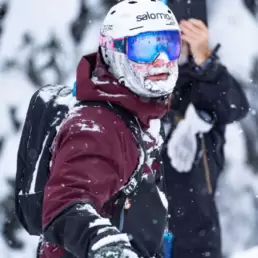 Skier sporting a snow-encrusted beard and a content expression, reaping the rewards of an exceptional run at White Grizzly cat skiing in BC, Canada.