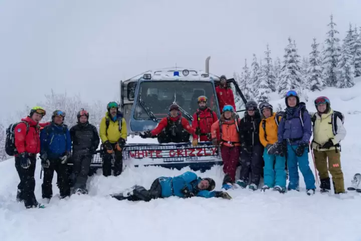 Warm reunions at the ski cat: Skiers sharing smiles and stories after an unforgettable powder run, capturing the camaraderie and thrill of White Grizzly cat skiing in BC, the best getaway in Canada.
